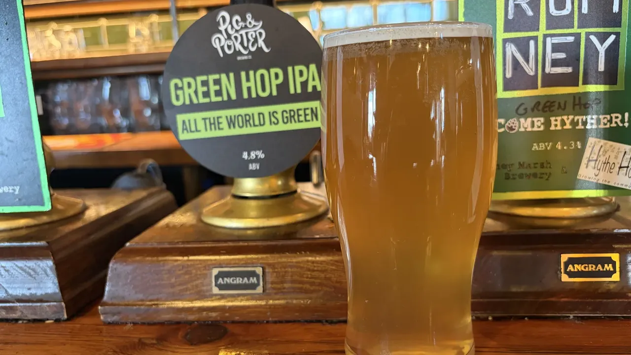 A pint of green hop beer at Harbour Inn, in front of the Pig & Porter All The World Is Green and Romney Marsh Come Hyther Green pump clips