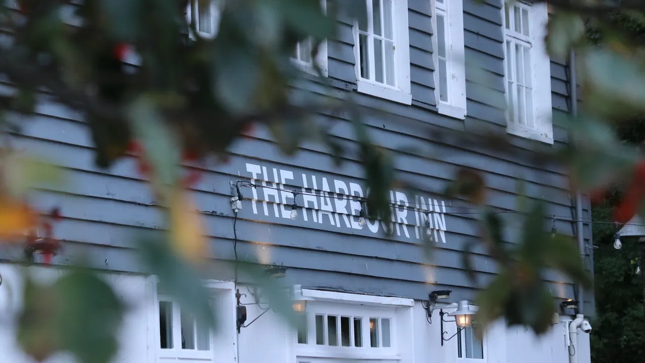 Harbour Inn's white weatherboarded frontage with its name painted proudly across the front