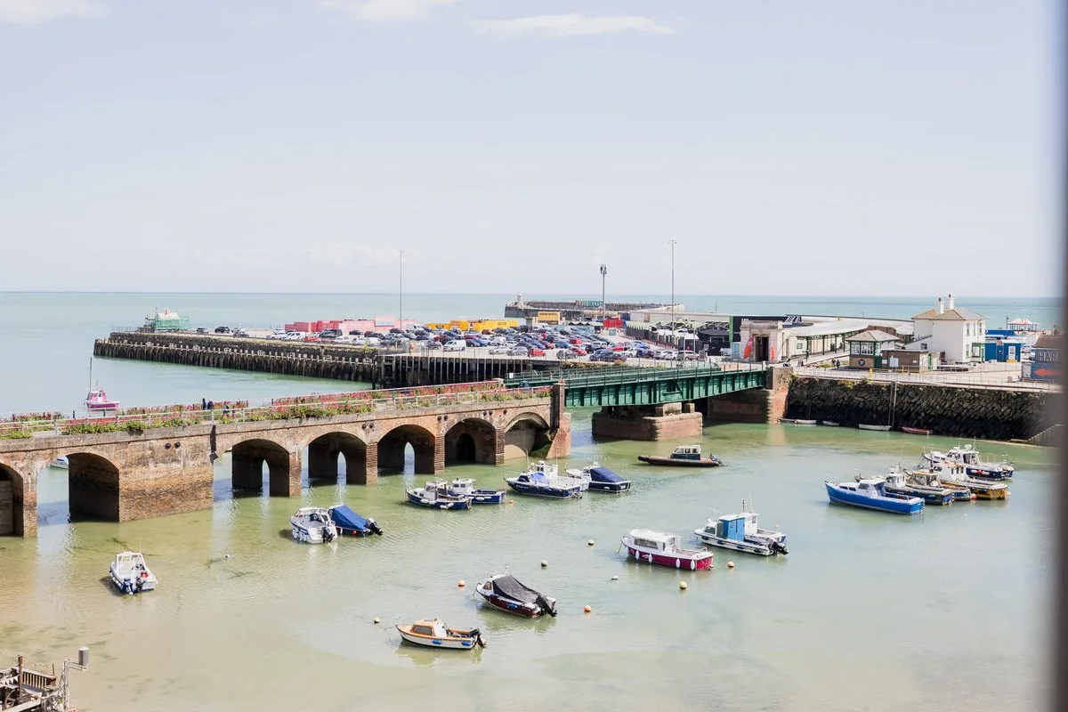 Folkestone Harbour at low tide from London & Paris Hotel, with boats, the viaduct and the Harbour Arm