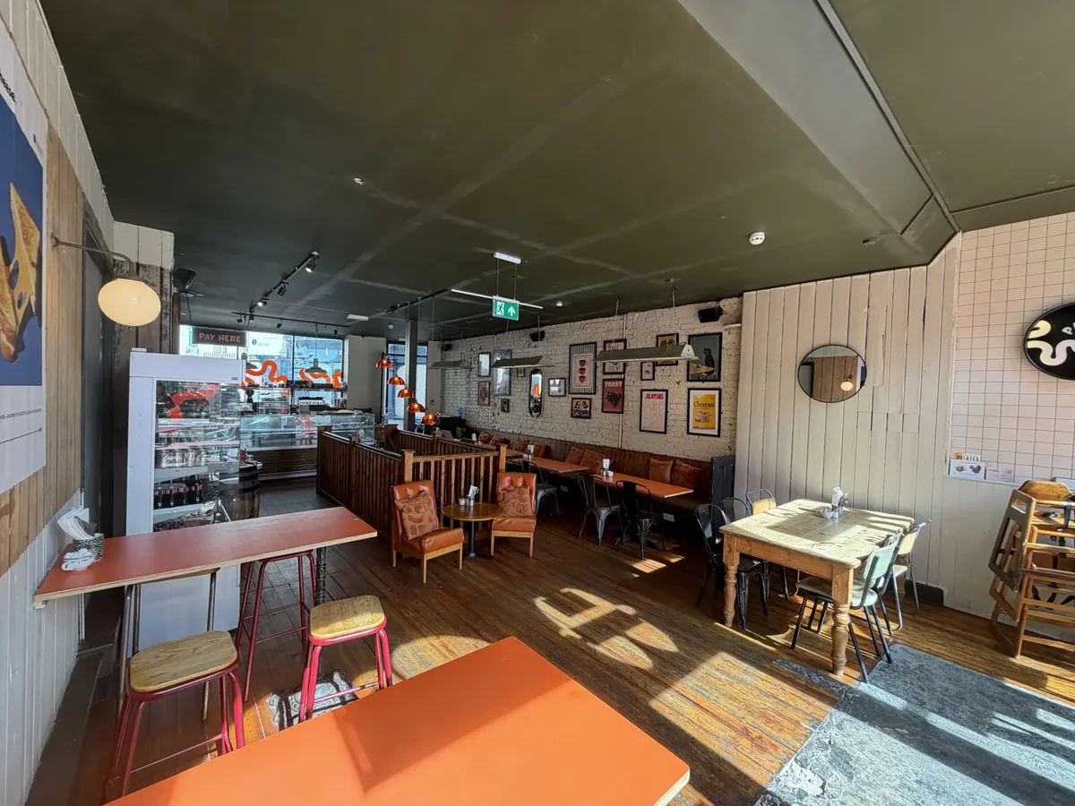 Panataria’s bright counter and dining room in Folkestone, with orange tables and booth seating