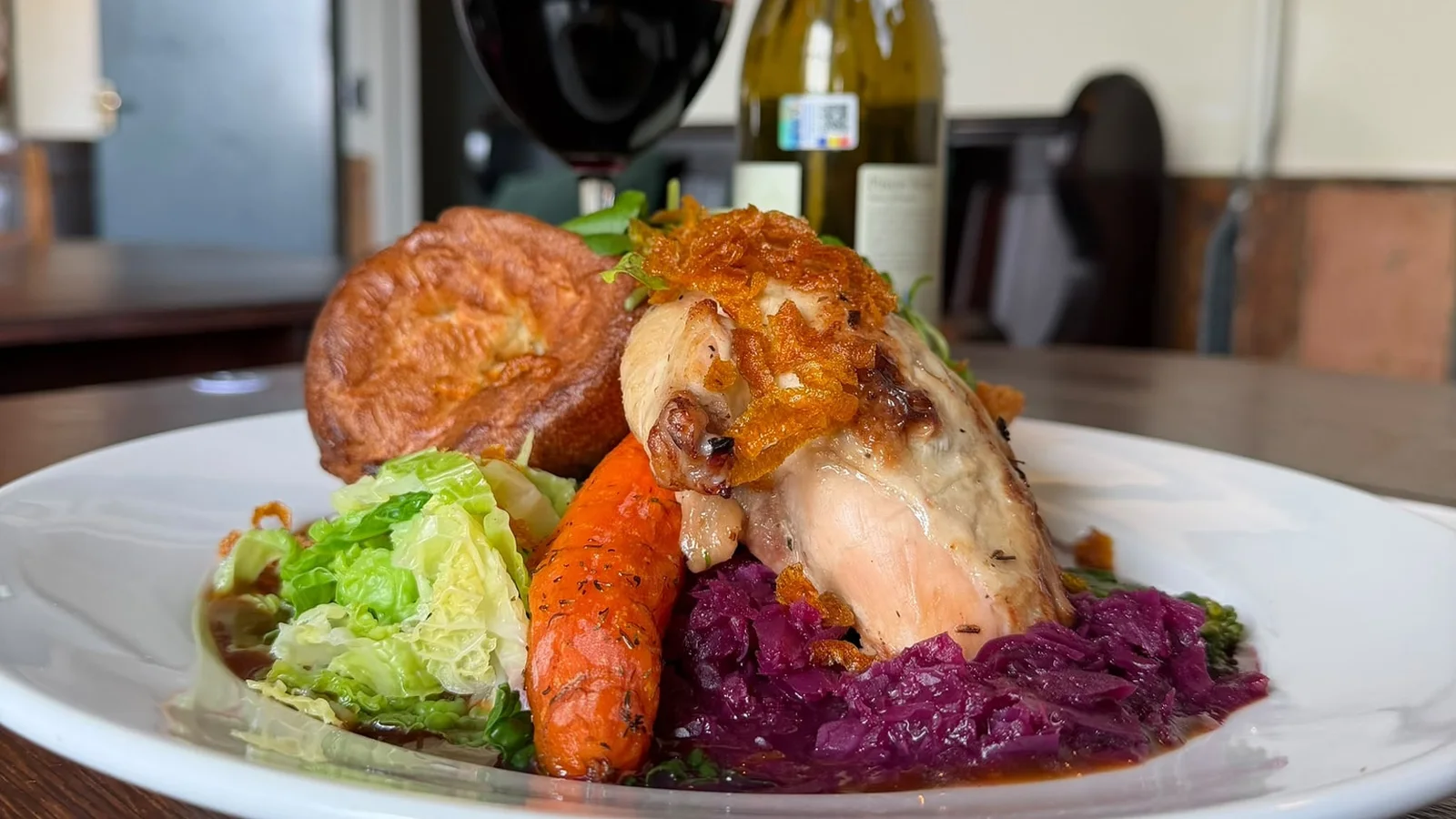 A roast chicken Sunday dinner with a Yorkshire pudding, roast carrot, savoy cabbage and red cabbage at The Ship Inn, Sandgate
