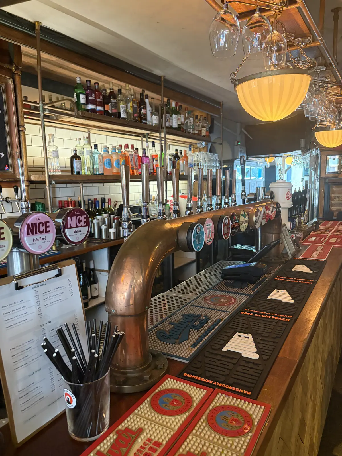 The Pullman bar counter with taps and hanging lamps