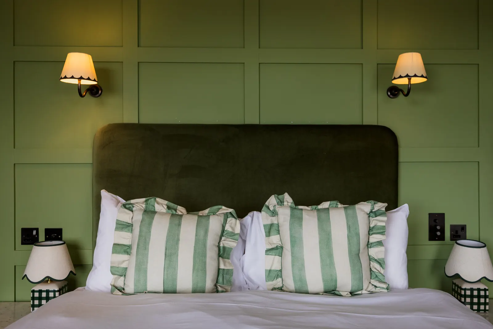 Room 2 at London & Paris Hotel, Folkestone: a double bed with striped cushions and green panelling