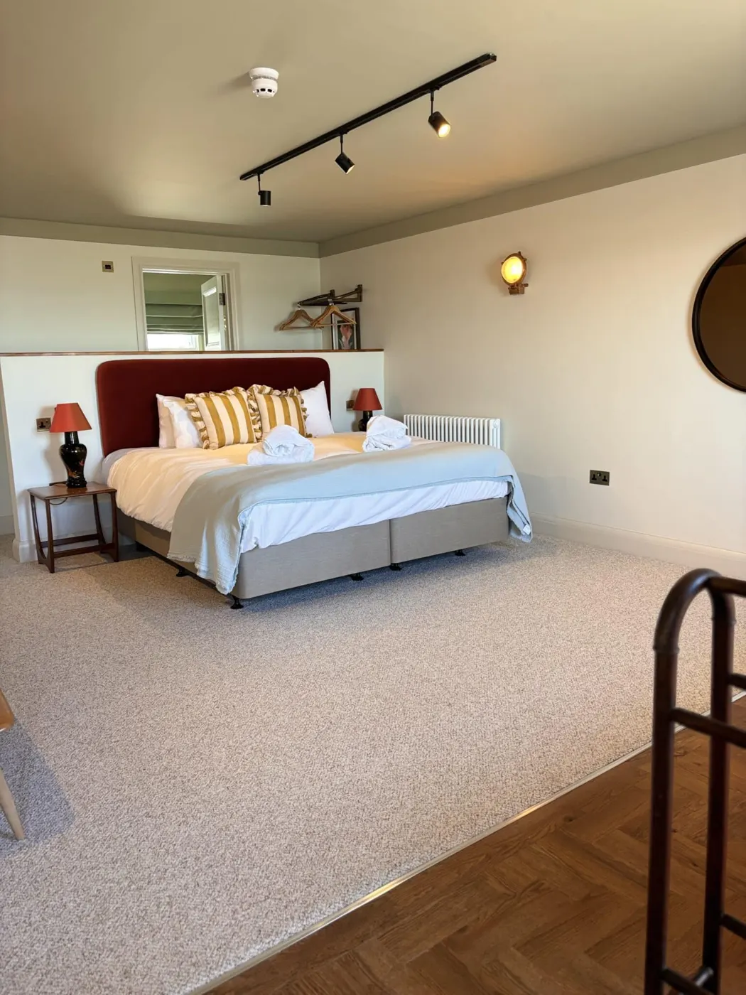 The suite: a spacious room with track lighting and a large bed