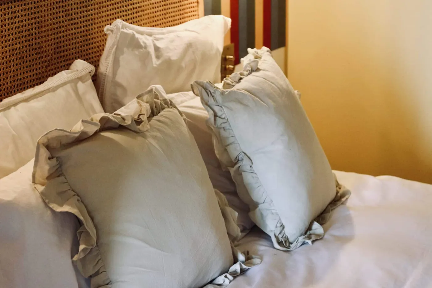Room 7: a bed dressed with ruffled linen cushions