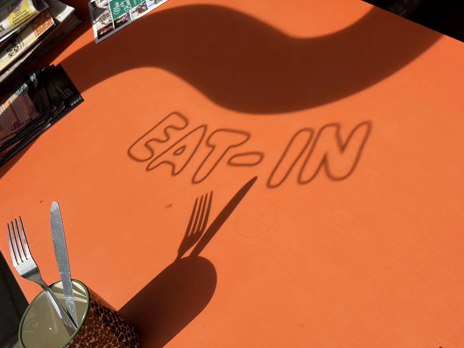 Orange table top with EAT-IN lettering