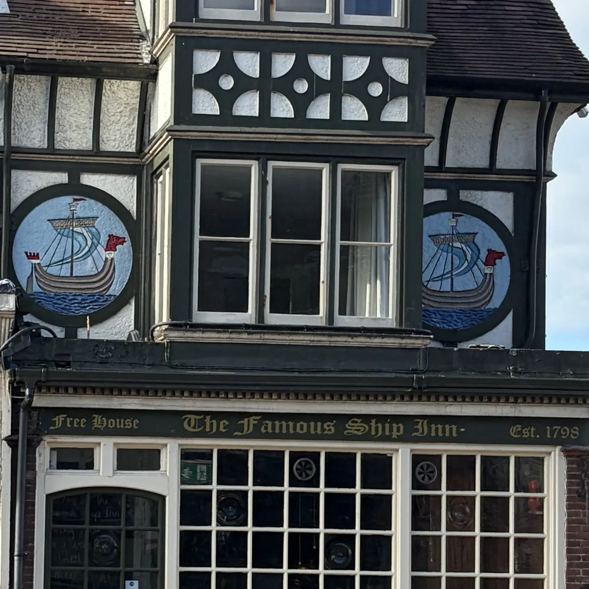 The Ship Inn’s black-and-white mock-Tudor front on Sandgate High Street, with its painted ship roundels and pub sign