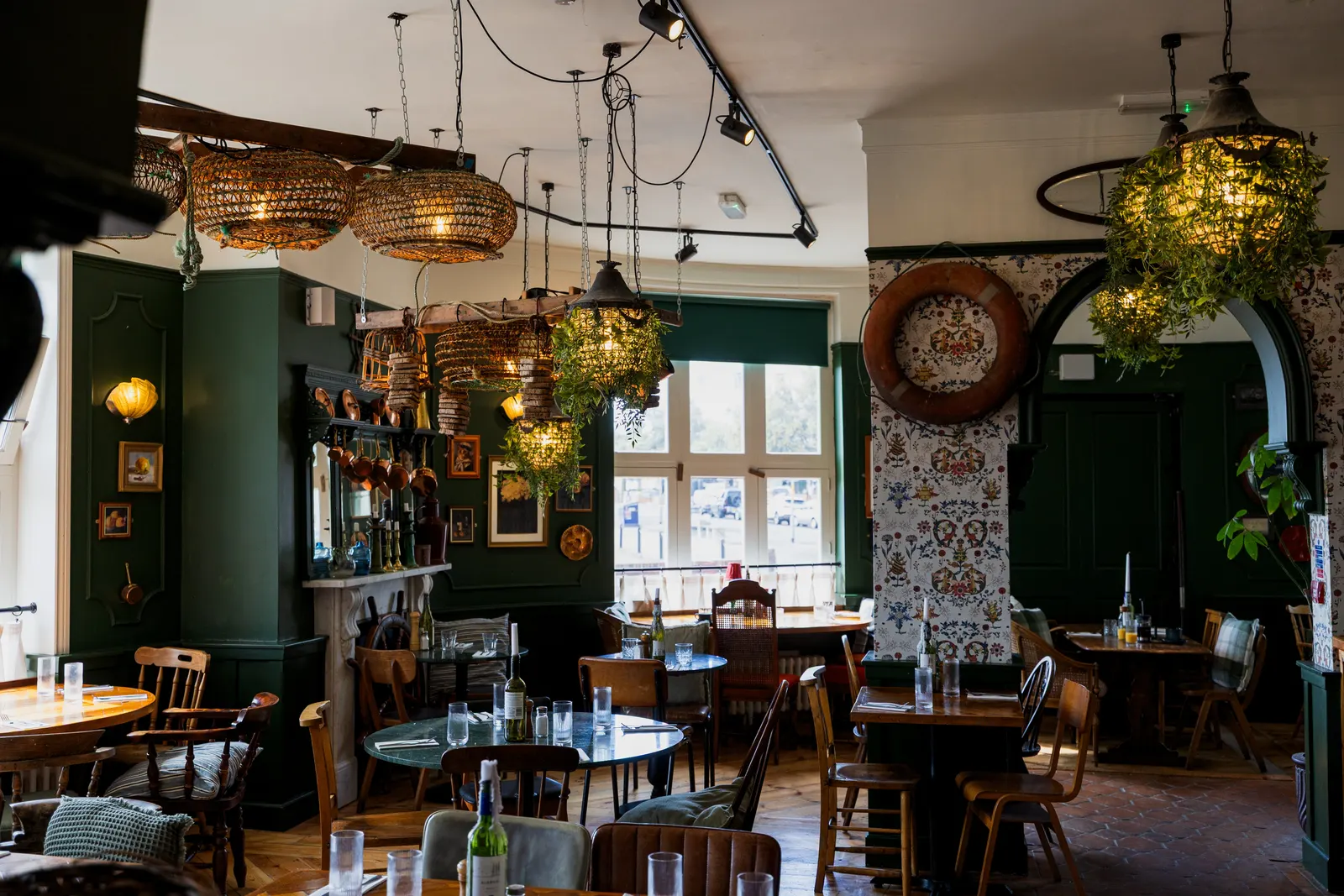 The restaurant at London & Paris Hotel on Harbour Street, Folkestone, with rattan lights and plants