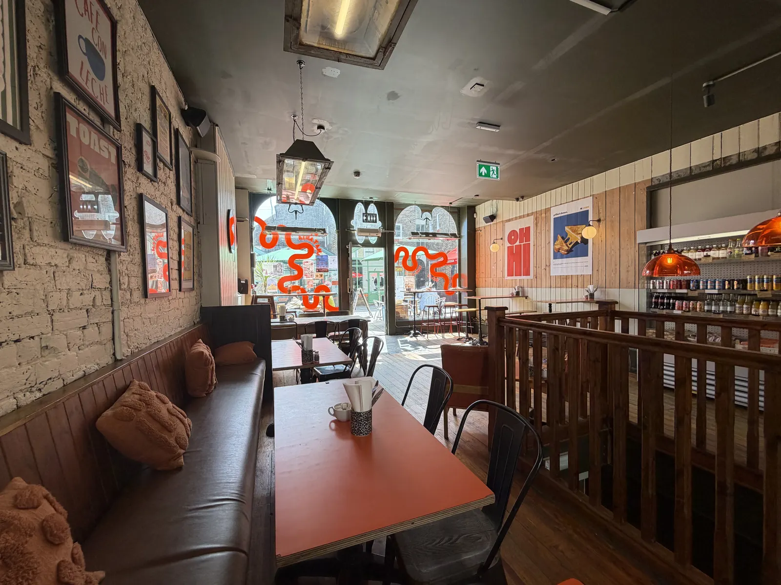 Banquette seating and orange tables in Panataria's café on Rendezvous Street, Folkestone