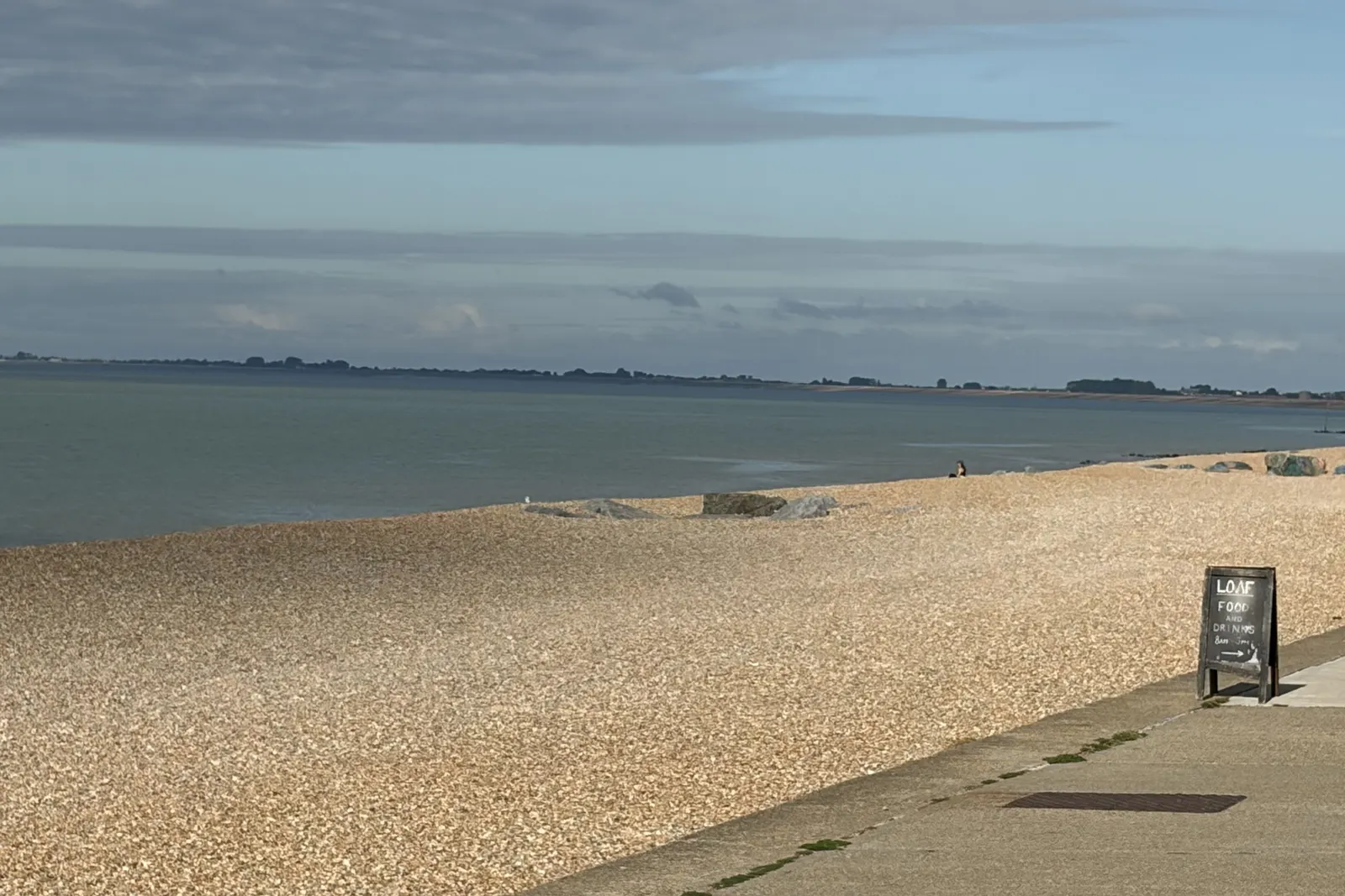 The promenade and shingle beach at Sandgate, Kent, looking out to sea