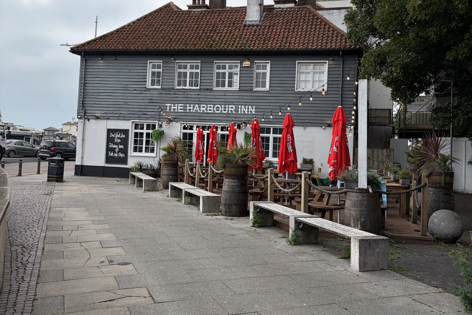 Harbour Inn's weatherboarded front and forecourt benches on Harbour Street, Folkestone