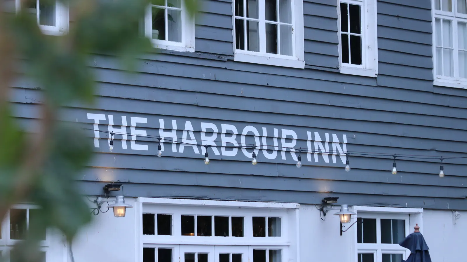 Harbour Inn name painted across the white weatherboarding on Harbour Street, Folkestone