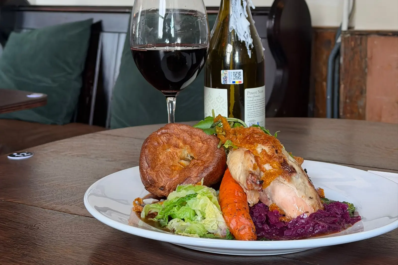 A roast chicken dinner with red cabbage and greens, with a glass of red, at The Ship Inn, Sandgate